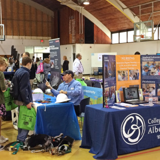 Students milling around booths at STEM Fair at the Roanoke Island campus of COA.