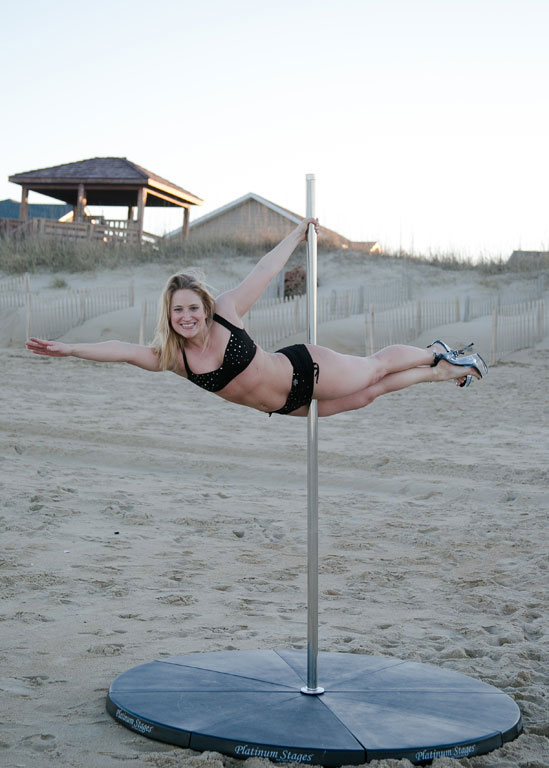 Chel Rogerson pole dancing on the beach. Photo K. Wilkins Photography
