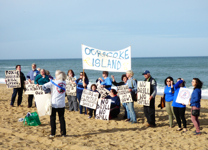 Organizing on the beach for a group photo. The signs from Ocracoke were brought out of the closet from the attempt in the 1990s to lease oil/gas sites off North Carolina.