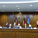 Dare County Commissioners voting "aye" in support of a resolution opposing offshore drilling.