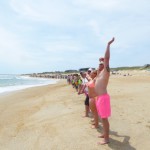 Hands linked at noon in Nags Head for Hands Across the Sand. Photo, Kip Tabb.