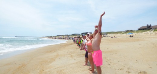 Hands linked at noon in Nags Head for Hands Across the Sand. Photo, Kip Tabb.