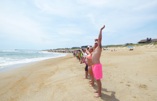 Hands linked at noon in Nags Head for Hands Across the Sand. Photo, Kip Tabb.