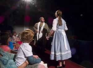 Belle confronting Le Feu about her father's scarf. Action taking place in the middle of the audience.