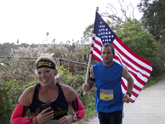 Matthew Cartwright from Hatteras, carrying the American flag throughout the Outer Banks Marathon. Matthew finished with a time of 4:41
