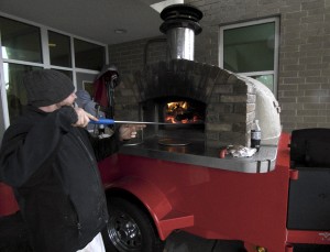 Making pizza at the Corolla Pizza mobile oven, day two. The winter jacket was a necessity.