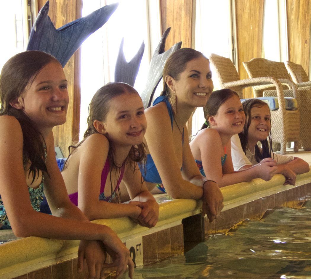 Mermaids and King Triton on the end. Hannah Burgess, professional mermaid and instructor, is second from the left.