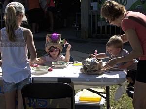 The creation of great art. Young artists make their own paper bag hats.