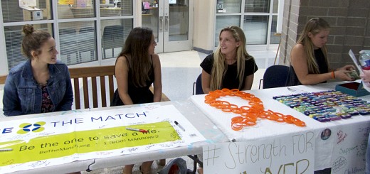 Helping to pay for treatment and research. First Flight High School students man Sawyer's support table.