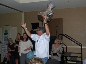 Helping to raise funds at the Chef's Challenge auction. Food Pantry board member, Mike Pringle, urges the bid higher.