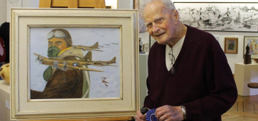 Don Bryan with prize winning painting, Raid on Regensburg, at Ghost Fleet Gallery's self-portrait show in April.
