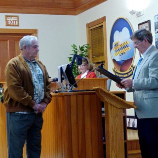 Retiring Mayor Cliff Perry with incoming Mayor Gary Perry (no relation) receiving resolution of appreciation from Kitty Hawk Town Council.