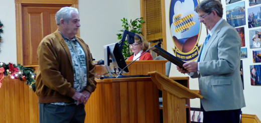 Retiring Mayor Cliff Perry with incoming Mayor Gary Perry (no relation) receiving resolution of appreciation from Kitty Hawk Town Council.
