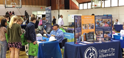 Students milling around booths at STEM Fair at the Roanoke Island campus of COA.