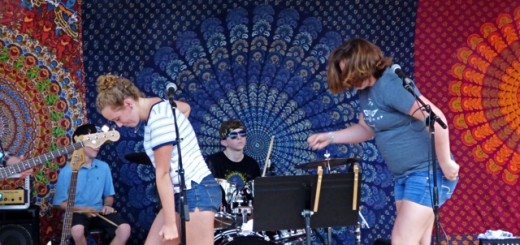 Kamea Blake and Grace Deichler showing some funky moves performing Uptown Funk, with Jonah Wills on drums.