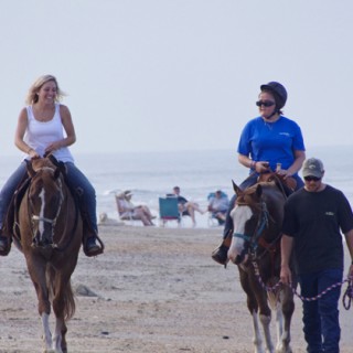 Riding on the beach in Corolla. (Lto R)LeeAnn McGraw, Maggie, Cody Edwards leading the horse. Cody walked the length of the ride.
